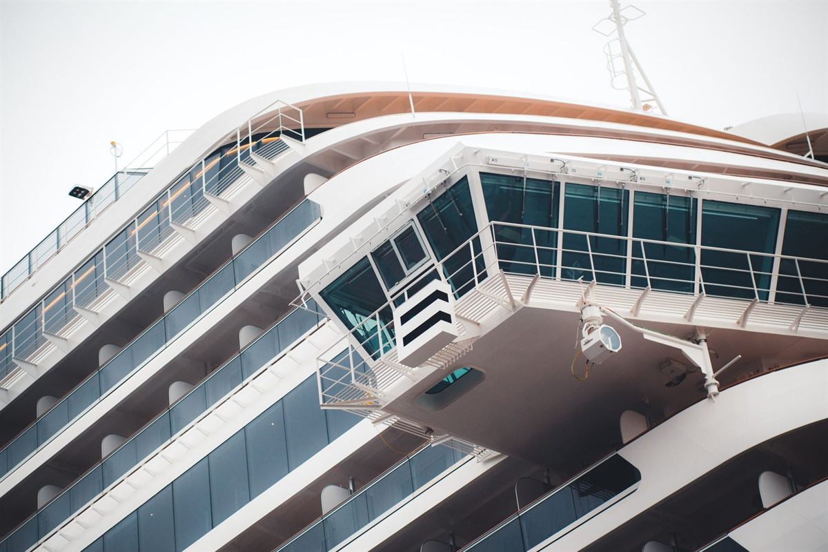 The curved white superstructure and bridge wing of a cruise ship